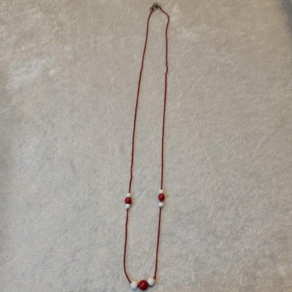 Red chain necklace with red and white ac